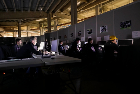 Deputy Director of Photography Denis Paquin, front left, and colleagues edit during the Super Bowl blackout, Sunday, Feb. 3, 2013, at the Superdome in New Orleans. (AP Photo/ Julie Jacobson)